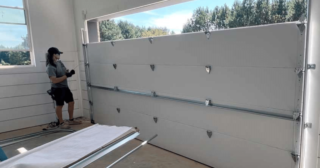 Technician installs a new garage door frame.
