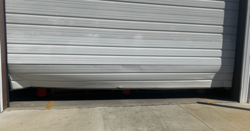 Damaged white metal garage door