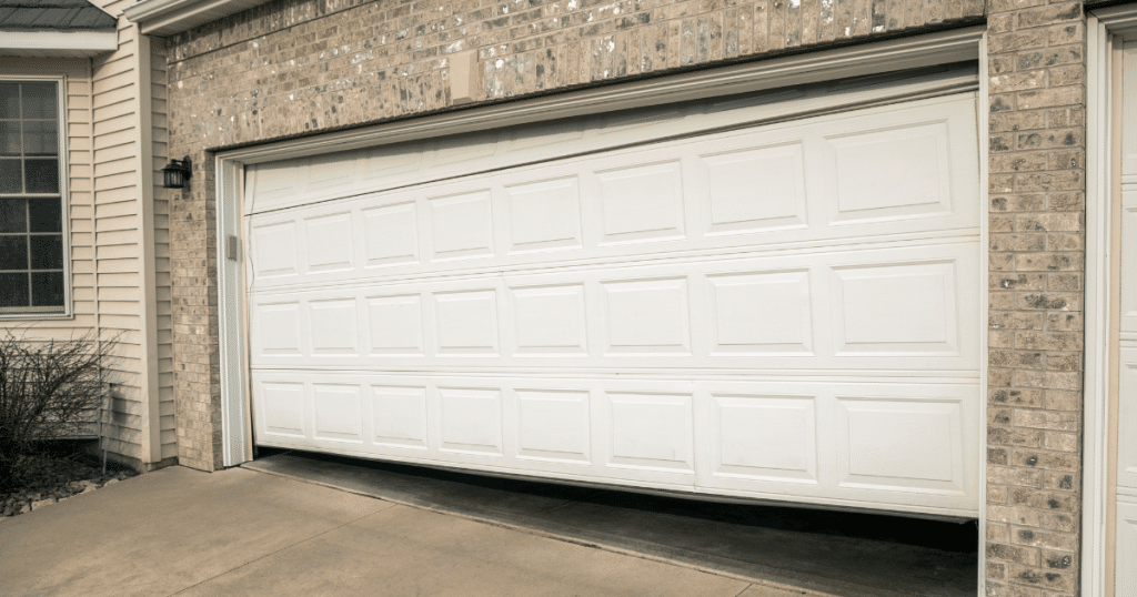 Misaligned white garage door