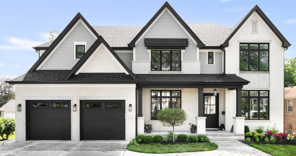 black garage doors on white house